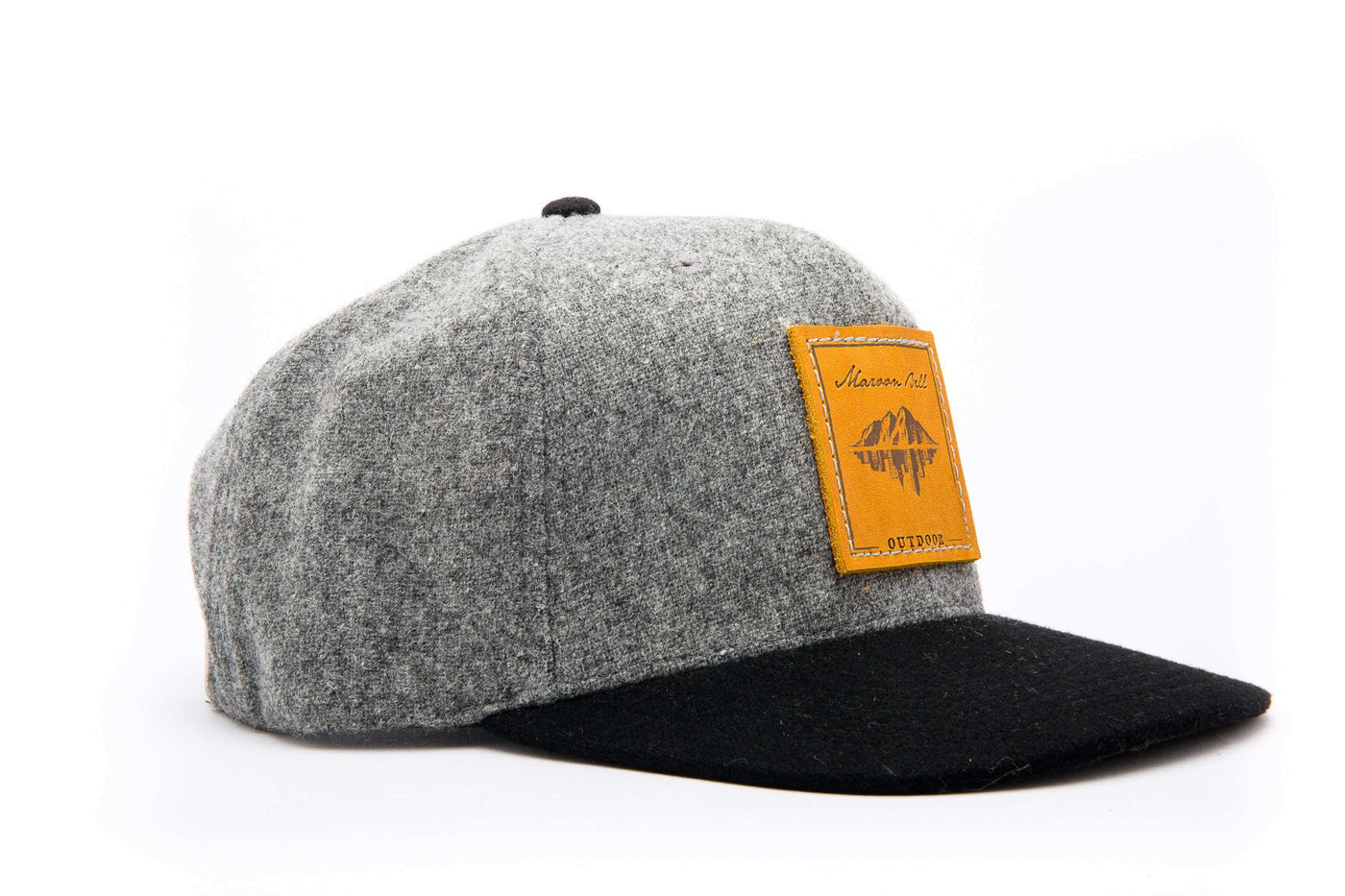 A grey Melton wool baseball hat with a flat black bill and a brown leather patch on the front with the Maroon Bell Outdoor branding.